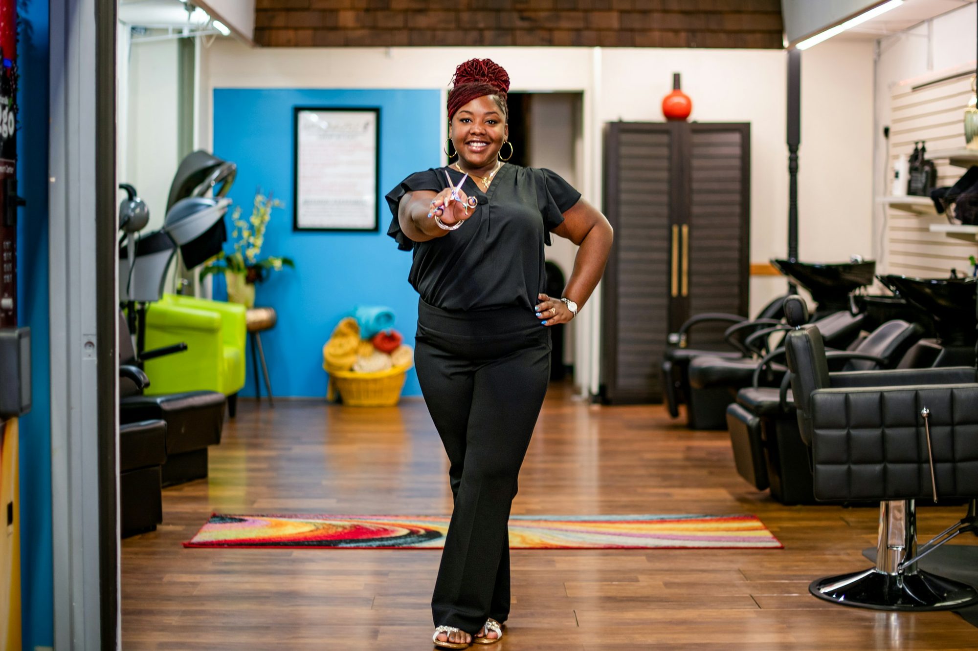 A salon owner standing in her bright salon